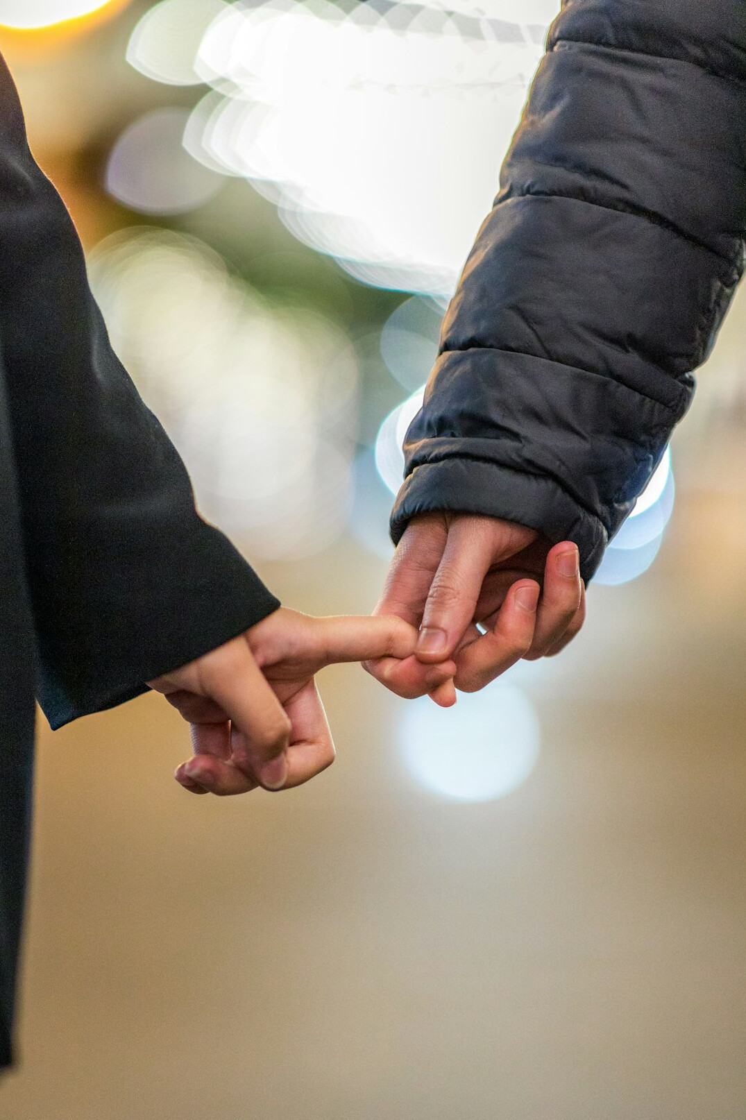 couple holding hands at event
