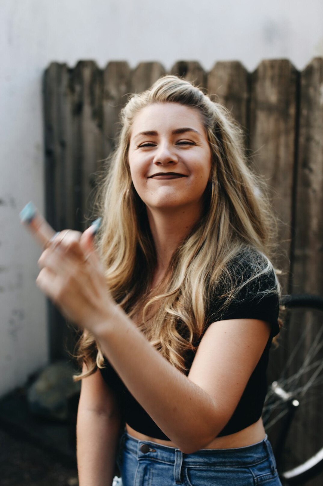 Portrait of a smiling Danish woman in a cozy sweater giving a thumbs up